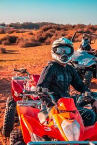 Experience the thrill of quad biking with helmets in Morocco's vast desert landscape.